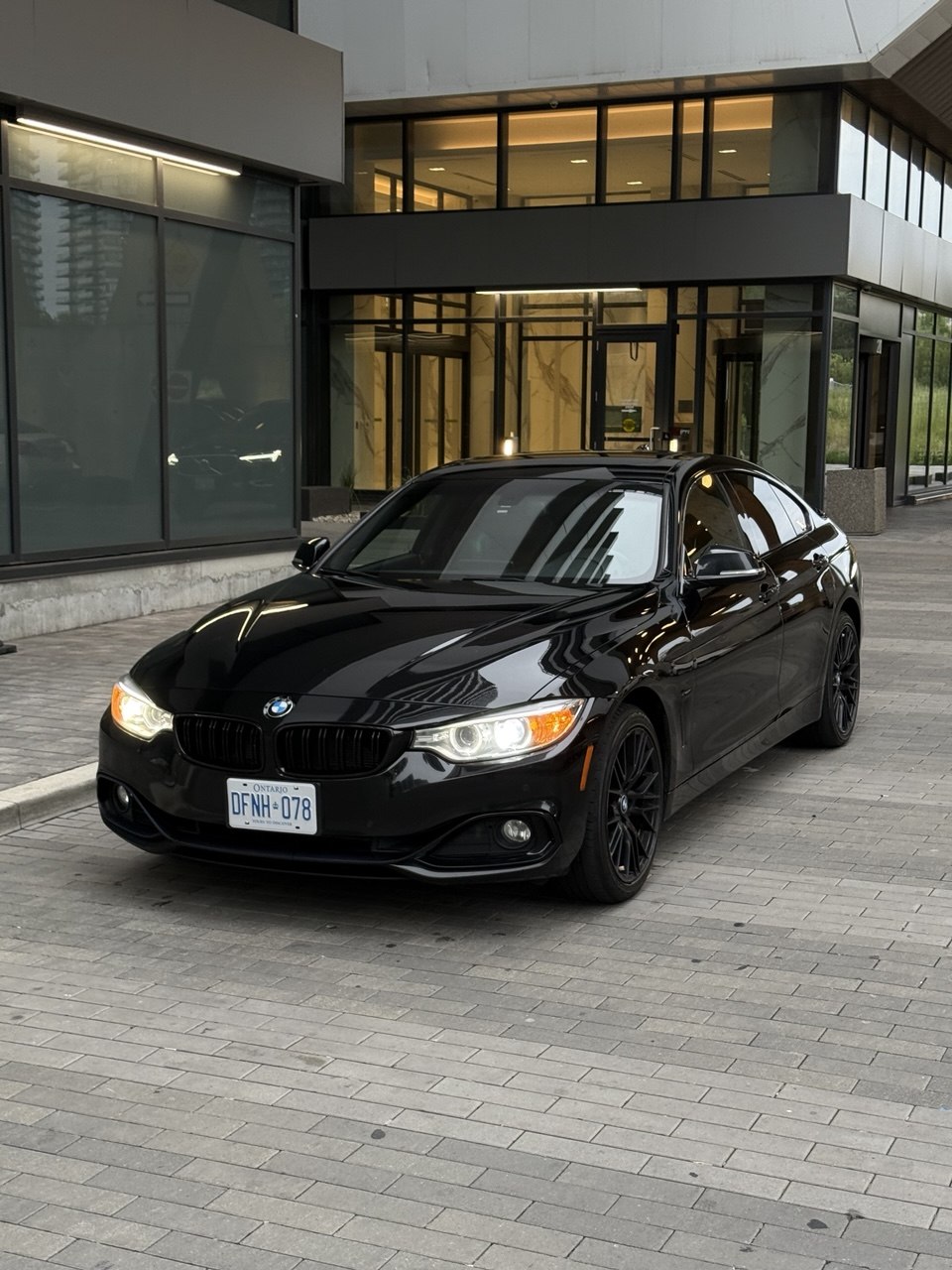 Foam-covered black car during an exterior wash